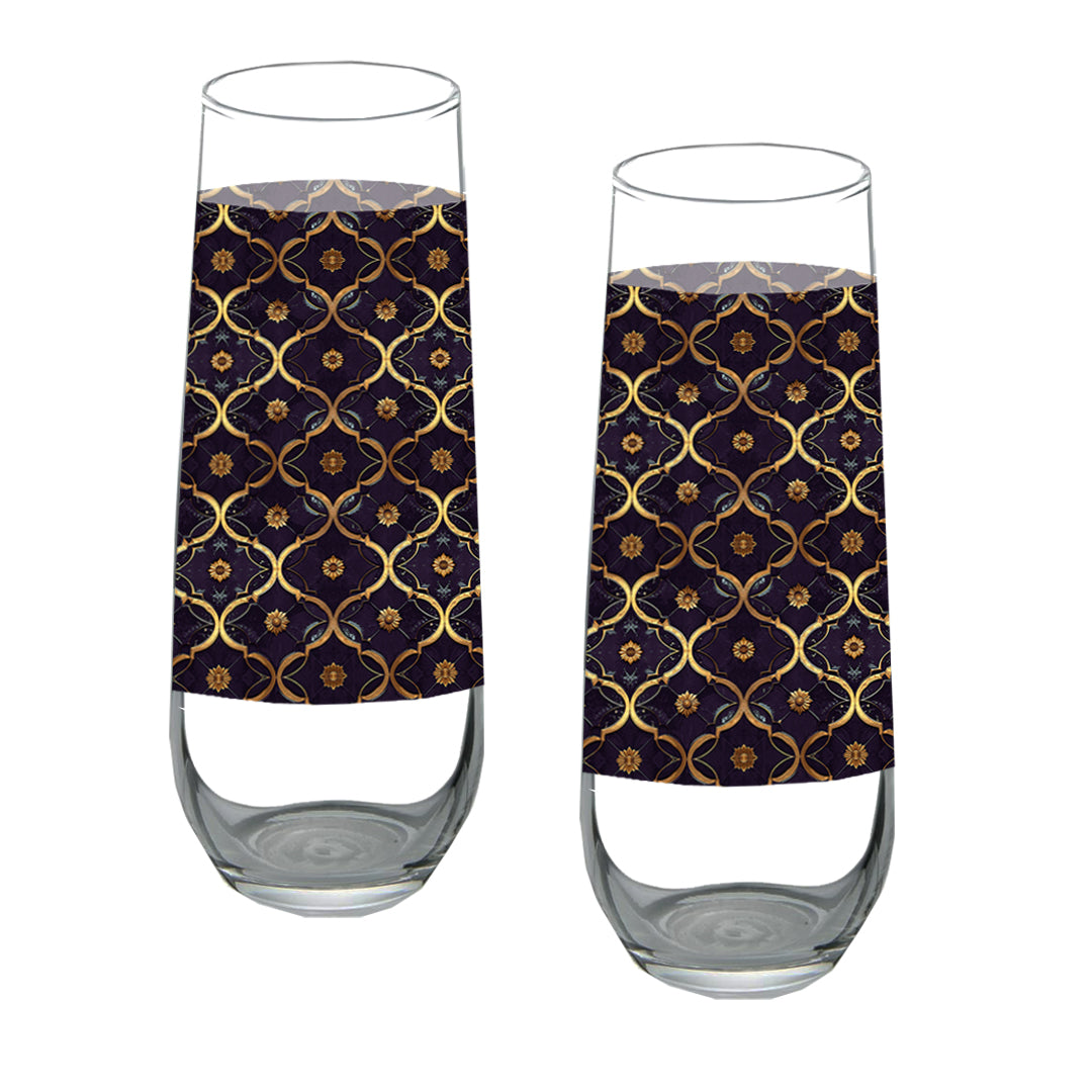 Two stemless champagne glasses with a violet and gold wrap design on a white background