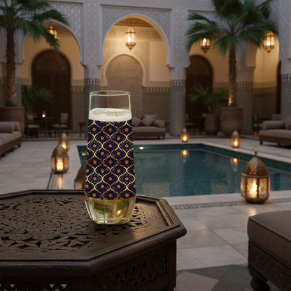 Midnight Marrakech stemless champagne glass with violet and gold pattern on a table by a poolside in an elegant outdoor setting.