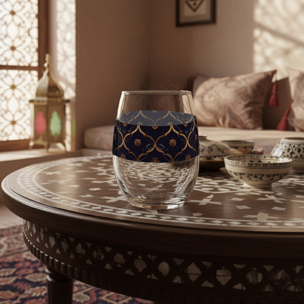 Midnight Marrakech stemless wine glass with a violet and gold design, sitting on a Moroccan table with a cozy bohemian room setting